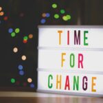 Colorful illuminated sign displaying the motivational message 'Time for Change'.