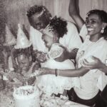 Happy family celebrating a birthday with cake and confetti indoors. Laughter and joy fill the atmosphere.
