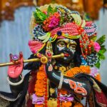 A colorful figurine of a Hindu deity adorned with flowers and ornaments in Rangpur, Bangladesh.
